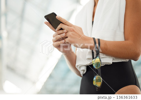 Phone, hands and athlete typing at swimming pool for social media, networking and internet app. Technology, swim and woman with smartphone for website, online sport or training, workout and exercise 136361633