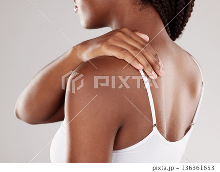 African woman, back pain and injury with health issue, muscle tension and inflammation on a grey studio background. Female person, body ache or model with joint strain, sore and swollen with stress 136361653