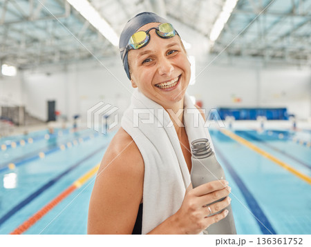 Portrait, swimming pool and woman smile with bottle for exercise, workout or training. Face, happy and swim athlete with water for nutrition, fitness and healthy body, wellness or hydration in Canada Portrait, swimming pool and woman smile with bottle for exercise, workout or training. Face, happy and swim athlete with water for nutrition, fitness and healthy body, wellness or hydration in Canada 136361752