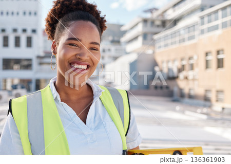 Smile, woman builder and portrait on site for construction, building or infrastructure maintenance in the city. Happy, industrial and an African architect, engineer or contractor in safety or labor Smile, woman builder and portrait on site for construction, building or infrastructure maintenance in the city. Happy, industrial and an African architect, engineer or contractor in safety or labor 136361903