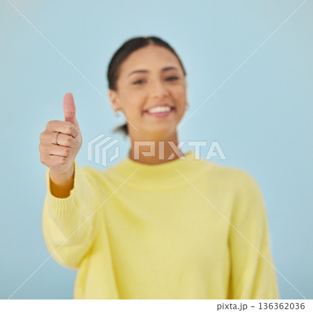 Happy woman, portrait and thumbs up for good job, approval or winning against a studio background. Female person smile with like emoji, yes sign or OK for agreement, thank you or positive feedback 136362036
