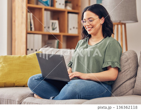 Sofa, laptop and woman or student in e learning, online education and typing for university or work from home research. Computer, information or knowledge of young person on couch and college website Sofa, laptop and woman or student in e learning, online education and typing for university or work from home research. Computer, information or knowledge of young person on couch and college website 136362118