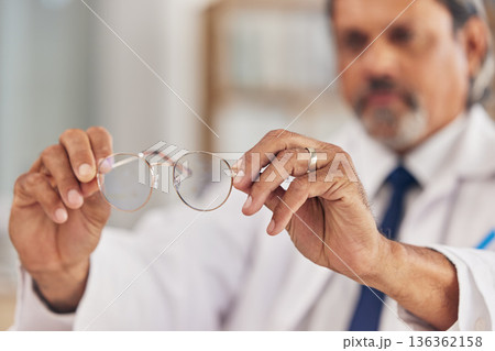 Optometrist, man and glasses in hand for vision or eyesight or prescription lens for worker. Doctor, closeup and frames in workplace with eyewear for wellness or focus with medical expert for care. 136362158