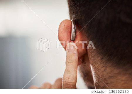 Closeup of ear, hearing aid and man with disability from the back for support, improve listening or amplifier with mockup space. Deaf patient, face and audiology implant to help volume of sound waves 136362180