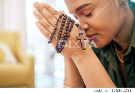 Young woman, prayer and rosary in home, focus and mindfulness for faith, religion and gratitude with hope. African girl, praying hands and cross jewellery for peace, mental health or worship to God Young woman, prayer and rosary in home, focus and mindfulness for faith, religion and gratitude with hope. African girl, praying hands and cross jewellery for peace, mental health or worship to God 136362251