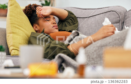 Sick, pills and black woman on sofa with tissue paper, flu and headache from viral infection in her home. Bacteria, migraine and African lady with virus, fatigue and nausea medicine in living room Sick, pills and black woman on sofa with tissue paper, flu and headache from viral infection in her home. Bacteria, migraine and African lady with virus, fatigue and nausea medicine in living room 136362283