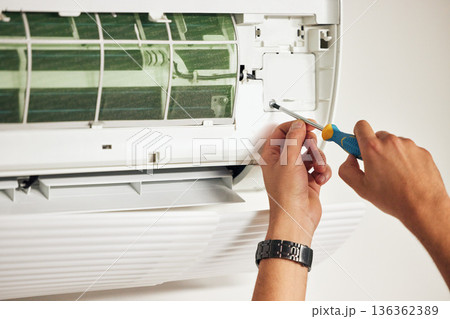 Maintenance, air conditioner and hands of man with screwdriver for problem solving on machine. Aircon, ac repair and handyman service with technician, electrician or contractor working on ventilation Maintenance, air conditioner and hands of man with screwdriver for problem solving on machine. Aircon, ac repair and handyman service with technician, electrician or contractor working on ventilation 136362389