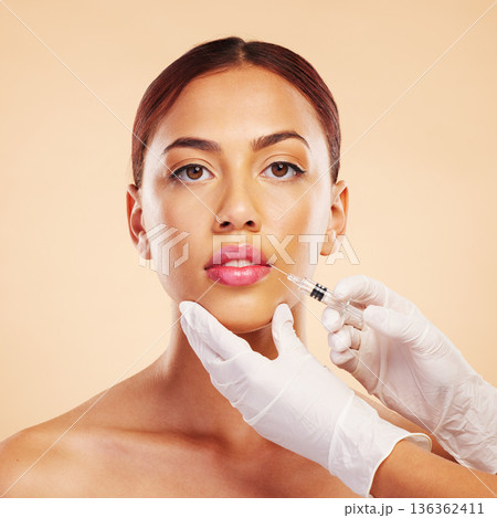 Portrait, woman or plastic surgery with a needle, lip filler and cosmetics isolated on studio background. Hands, lips or face of model with injection, dermatology and beauty with medical procedure Portrait, woman or plastic surgery with a needle, lip filler and cosmetics isolated on studio background. Hands, lips or face of model with injection, dermatology and beauty with medical procedure 136362411