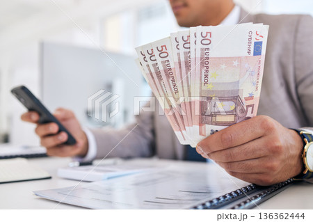 Businessman, money and phone with documents for accounting, budget planning or finance on office desk. Closeup of man or accountant hands with cash and smartphone in savings, audit or salary on table Businessman, money and phone with documents for accounting, budget planning or finance on office desk. Closeup of man or accountant hands with cash and smartphone in savings, audit or salary on table 136362444