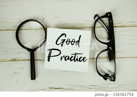 Good Practice text with eye glasses and magnifying glass on wooden background 136362758