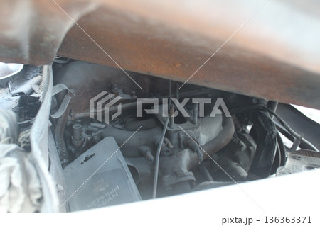 Car interior parts in white foam after a fire. Car repair Car interior parts in white foam after a fire. Car repair 136363371