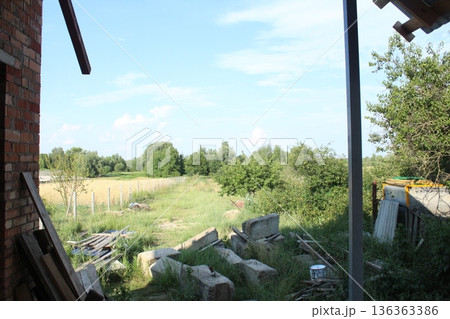 Construction beams on the ground.. Building Material Residues: Bricks, Concrete Beams on the Grass Construction beams on the ground.. Building Material Residues: Bricks, Concrete Beams on the Grass 136363386