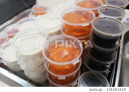 Black soy wasabi, ginger and white sauce in gravy boats close-up. Organization of food production Black soy wasabi, ginger and white sauce in gravy boats close-up. Organization of food production 136363428