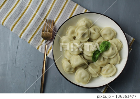 Dumplings on a plate, serving dinner, dumplings with filling. Homemade dishes: top view 136363477