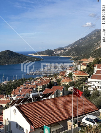 Scenic view of marina in coastal town with yachts and red rooftops, suitable for travel background 136363618