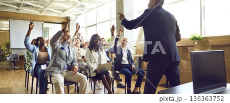 People colleagues raising hands to ask questions during business meeting in office. 136363752