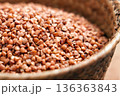 Raw buckwheat groats in woven basket. Natural gluten free cereal ingredient in close up. 136363843