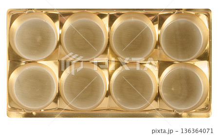 Golden plastic candy tray, eight round cells, isolated background 136364071