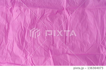 Crumpled texture of pink tissue paper, chaotic folds 136364073