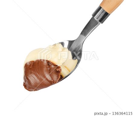 White and dark chocolate spread on spoon isolated 136364115
