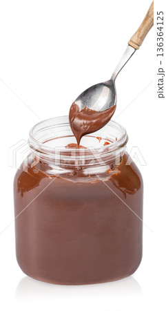 Chocolate spread in glass jar with spoon dripping, isolated on white Chocolate spread in glass jar with spoon dripping, isolated on white 136364125