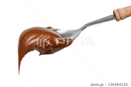 Creamy chocolate spread dripping from spoon isolated on white Creamy chocolate spread dripping from spoon isolated on white 136364126