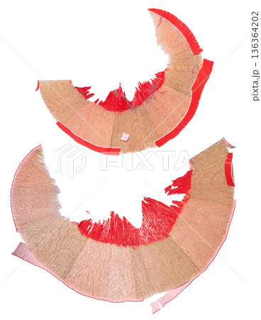 Wood shavings from a red pencil on an isolated background, macro 136364202