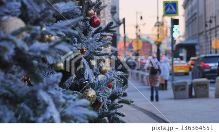 Snowy christmas tree decorating Moscow street during winter holidays 136364551