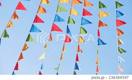 Colorful triangular flags waving in the wind in Moscow 136364597