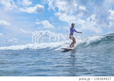 Girl Enjoys Longboard At Coast, Youthful Lady Rides Longboard Near Sunny Waves Girl Enjoys Longboard At Coast, Youthful Lady Rides Longboard Near Sunny Waves 136364917