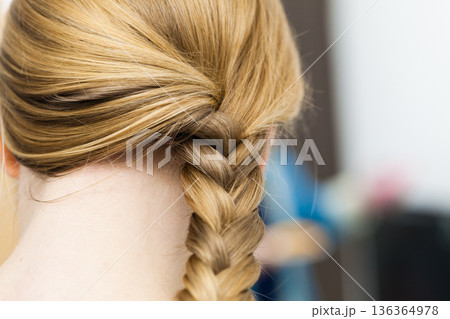 Closeup of woman blonde braided hair Closeup of woman blonde braided hair 136364978