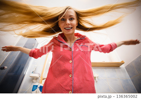 Woman showing her long blonde hair Woman showing her long blonde hair 136365002
