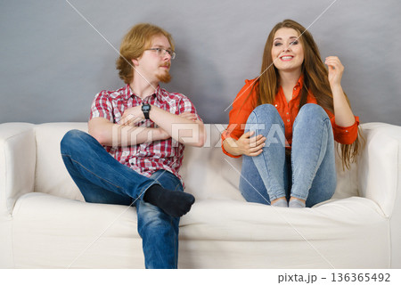 Happy man and woman sitting on sofa 136365492