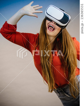 Girl wearing virtual reality goggles. 136365531