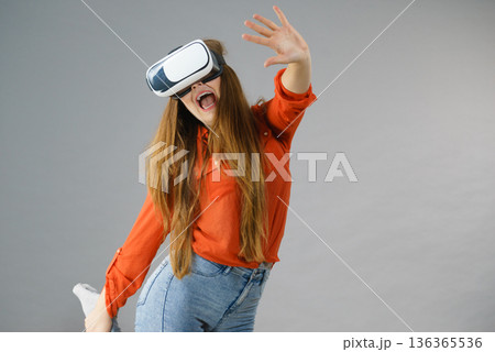 Girl wearing virtual reality goggles. Girl wearing virtual reality goggles. 136365536