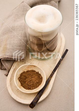 Latte coffee foam with cocoa powder on tray 136365567