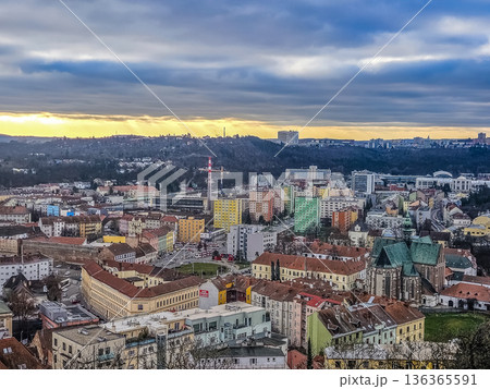 An epic high-angle cityscape of Brno at dusk. The view from spilberk hill captures the Old Town, including the Abbey of St. Thomas, under a dramatic, cloudy sky.. High quality photo An epic high-angle cityscape of Brno at dusk. The view from spilberk hill captures the Old Town, including the Abbey of St. Thomas, under a dramatic, cloudy sky.. High quality photo 136365591
