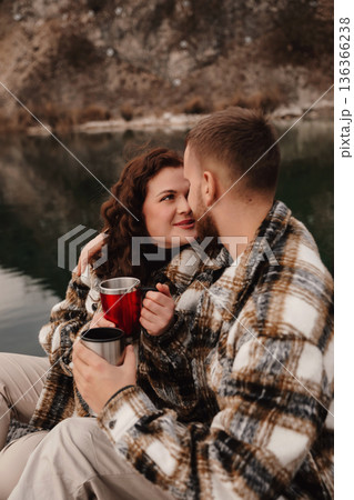 Couple enjoys warm drinks by the water while celebrating love on Valentines Day Couple enjoys warm drinks by the water while celebrating love on Valentines Day 136366238