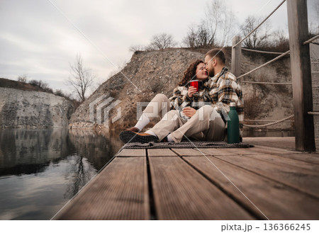 Couple shares a moment by the water on Valentines Day near a quiet spot surrounded by nature Couple shares a moment by the water on Valentines Day near a quiet spot surrounded by nature 136366245