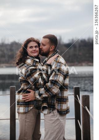 Couple enjoys romantic moment by a lake during winter season while celebrating their love on Valentines Day Couple enjoys romantic moment by a lake during winter season while celebrating their love on Valentines Day 136366267