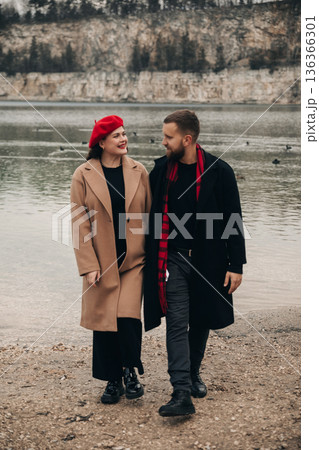 Couple walks by the water on Valentines Day, enjoying moments together near a scenic location 136366301