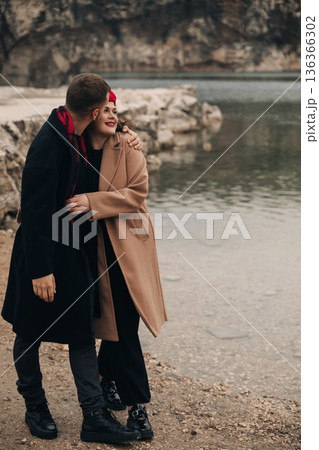 Couple enjoying time together by the water on Valentines Day in a natural setting 136366302