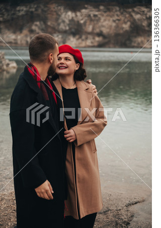 Couple shares a moment by the water on Valentines Day while enjoying their romance and connection in a natural setting Couple shares a moment by the water on Valentines Day while enjoying their romance and connection in a natural setting 136366305