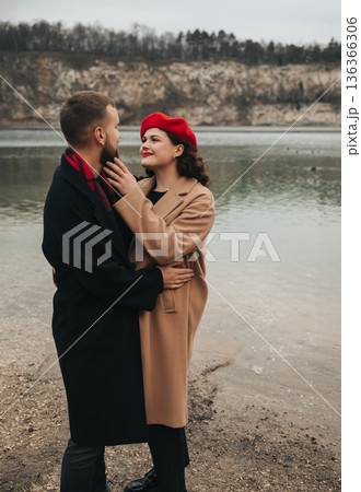 Couple enjoying a romantic moment by the water on Valentines Day in a scenic outdoor location Couple enjoying a romantic moment by the water on Valentines Day in a scenic outdoor location 136366306