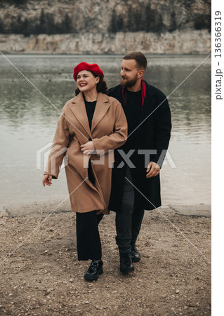 Couple walks by the water on a cold day enjoying each others company for Valentines Day Couple walks by the water on a cold day enjoying each others company for Valentines Day 136366319