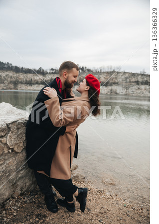 Couple enjoys a moment of love by the water on Valentines Day in a scenic location Couple enjoys a moment of love by the water on Valentines Day in a scenic location 136366329