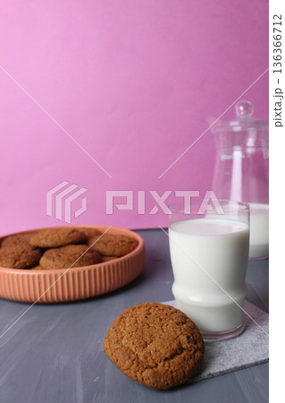Breakfast for children Biscuits with milk on a pink background with space for copyspace text. The concept of homemade baking. Breakfast for children Biscuits with milk on a pink background with space for copyspace text. The concept of homemade baking. 136366712
