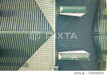 Top aerial view of building green shingle tiled roof construction. Abstract background, geometrical pattern. 136366833