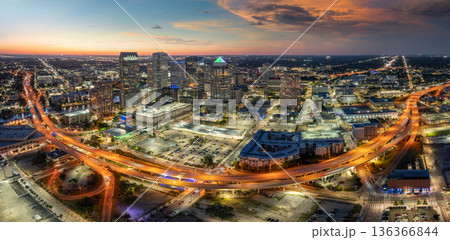 American city skyline with brightly illuminated high commercial buildings and high speed highway road. Night urban landscape of downtown district of Tampa in Florida, USA. 136366844