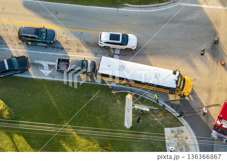 School bus and pick-up truck car crash with first responders helping at accident site on American street. Vehicle collision on road in USA 136366867